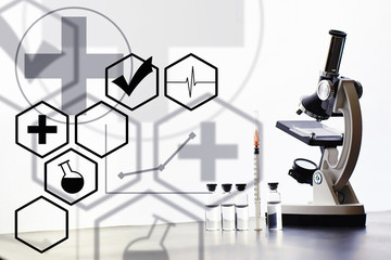 Research laboratory. Test tubes and microscope on the table. Double exposure.