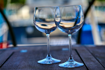 Pair of wineglasses against the yacht