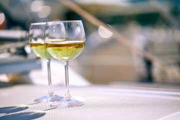 Pair of wineglasses against the yacht