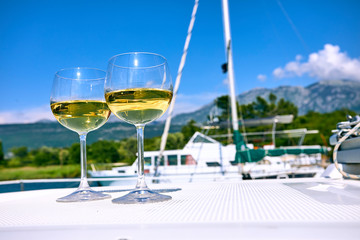 Pair of wineglasses against the yacht