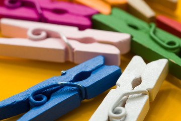 colored clothespins on a yellow background