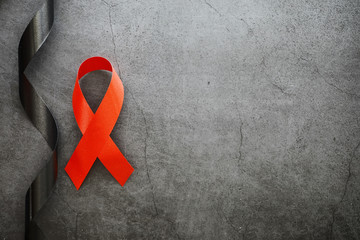 Symbol of human immunodeficiency virus disease. Red ribbon. A helping hand and support.