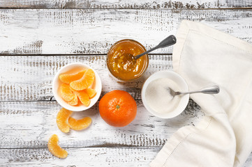 Citrus jam in glass jar, oranges and sugar