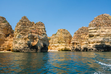 Fototapeta na wymiar Famous Rocks in Sea, Ocean, Lagos in Portugal. Popular summer travel destination and famous beach at Algarve coastline