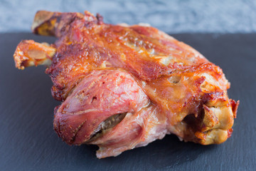 baked in the oven with spices pork knuckle on the black mantel