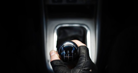 Gear lever. Manual Transmission. Hand on the gear shift in the car.
