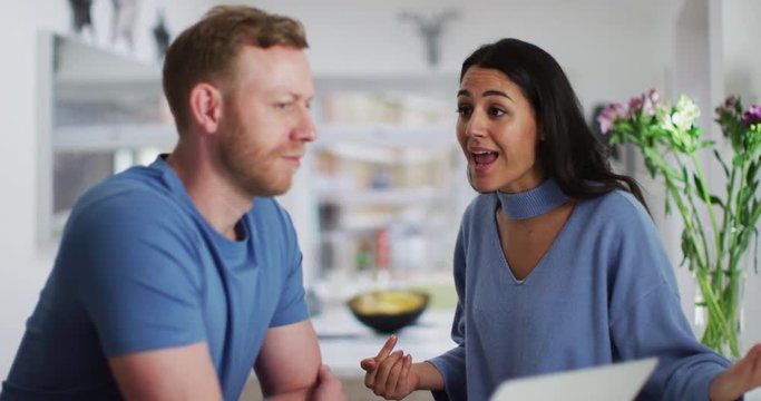 4K Couple having an argument at home with woman getting emotional & man looking at camera
