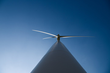 Wind power plant against blue sky