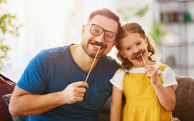  Father's day. Happy funny family daughter and dad with mustache .