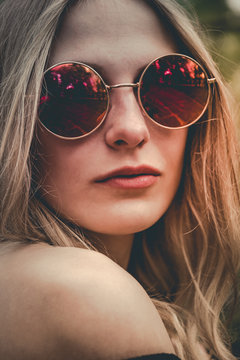 Woman in red round sunglasses