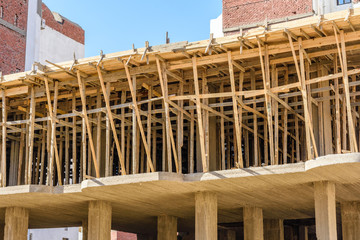 Obraz premium Construction of the new modern residential building, wooden framework. Hurghada, Egypt