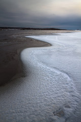 cloudy autumn day on the bank of the freezing river