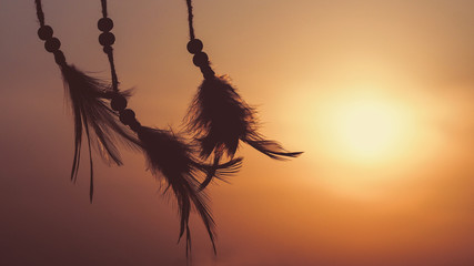 Blurred image, Dream catcher native american in the wind and blurred bright light background, hope...