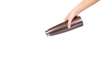 Hand with brown metal thermos, travel mug for hot drinks.