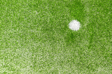 Green synthetic artificial grass soccer sports field with white penalty mark