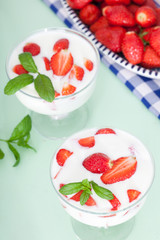 Strawberry yogurt with fresh strawberries in glass bowls. Healthy food for breakfast.