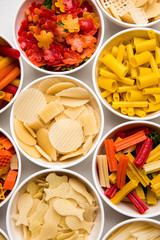 Snack pellets are non-expanded products made with raw materials like cereals, potatoes or vegetable powders, later processed using frying, hot air baking. multicoloured / shaped ready-to-eat snacks