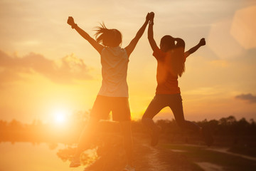 Fototapeta premium strong confidence woman open arms under the sunset.