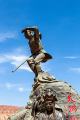 Aug 2017, Flaming Mountains, Xinjiang, China: statue from a scene of the Chinese epic “Journey to the west” when the monkey king and his companions reach the flaming mountains