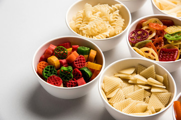 Snack pellets are non-expanded products made with raw materials like cereals, potatoes or vegetable powders, later processed using frying, hot air baking. multicoloured / shaped ready-to-eat snacks