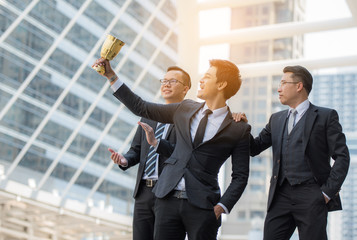 Businessmen appreciate the trophy.