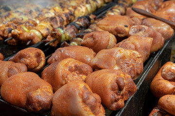 Roasted smoked pork legs for sale at christmas market. Krakow, Poland