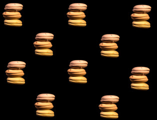 Set of many macaroni multicolored. Delicious macaroons isolated on black background. French sweet cookie