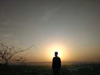 silhouette of man on background of sunset sky