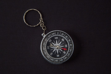 compass key chain on a black background