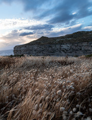 Windy and cloudy sunset at the cliffs