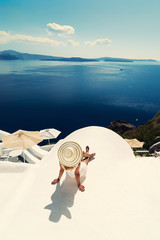 Luxury travel vacation woman looking at view on Santorini island