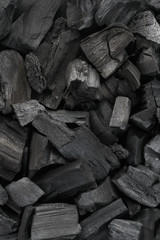 Black charcoal texture background. Close-up. Top view.