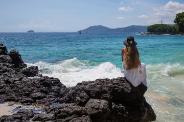 Happy  woman in white dress on tropical beach vacation