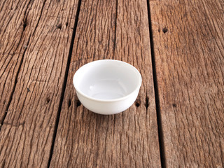 Fototapeta na wymiar Empty white bowl on wooden table