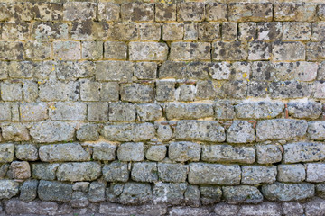 Old rough, weathered Stone wall.