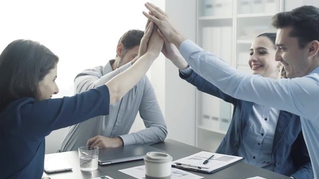 Cheerful successful business team giving a high five