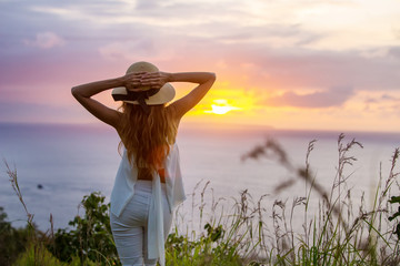  woman on the edge of a cliff and looking at sunset, Nusa Penida