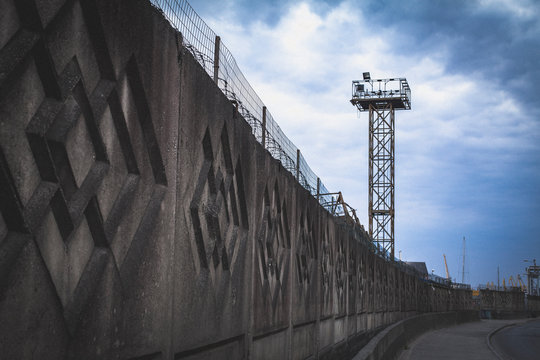 Prison Wall With Barbed Wire And Tower