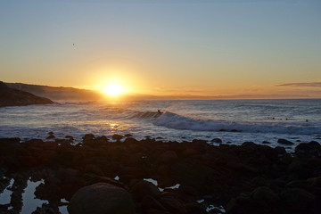 Surfer on wave, sunrise, south africa