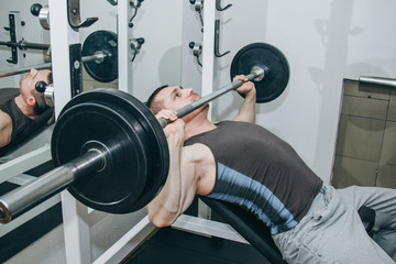 athlete shakes pectoral muscles in the center of training. exercise chest press. training tools in...