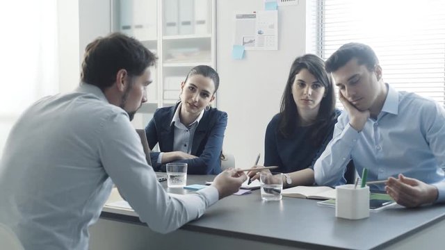 Recruitment team examining a boring talkative candidate