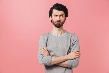 Handsome young confused bearded brunette man