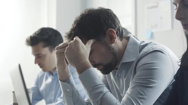 Exhausted businessman having an headache