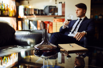decanter with wine on the table. blurred background.