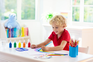 Kids paint. Child painting. Little boy drawing.