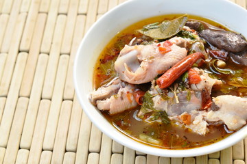 boiled chicken bone with herb and tamarind leaf Thai spicy soup on bowl