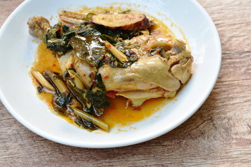 steamed spicy chicken thigh and leg with herb and chili on palte