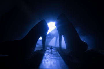 Artwork decoration. Silhouette of a man standing in the middle of the road on a misty night with...