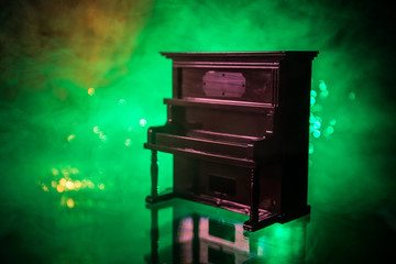 Creative concept. Artwork decoration with piano on dark toned foggy background with light.