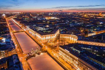Night wide angle view of Fontanka river embankment and Lomonosov bridge in St. Petersburg